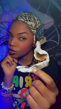 a woman holding a donut in her hand
