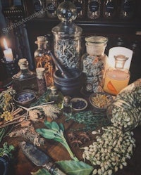 a table full of herbs and spices on a wooden table