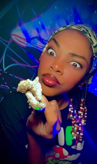 a woman is holding a piece of food